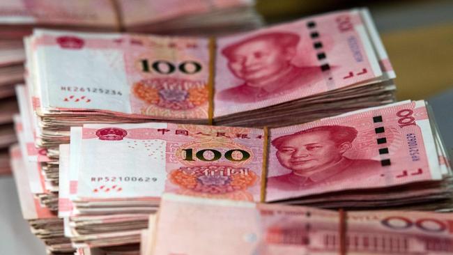 Bundles of 100 yuan notes at a bank in Shanghai. Picture: Johannes Eisele/ AFP.