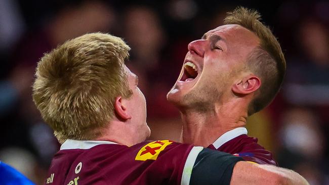 Queensland captain Daly Cherry-Evans (R) embraces teammate Tom Dearden as they celebrate their victory in the State of Origin rugby league match between Queensland and New South Wales in Brisbane on July 13, 2022. (Photo by Patrick HAMILTON / AFP) / -