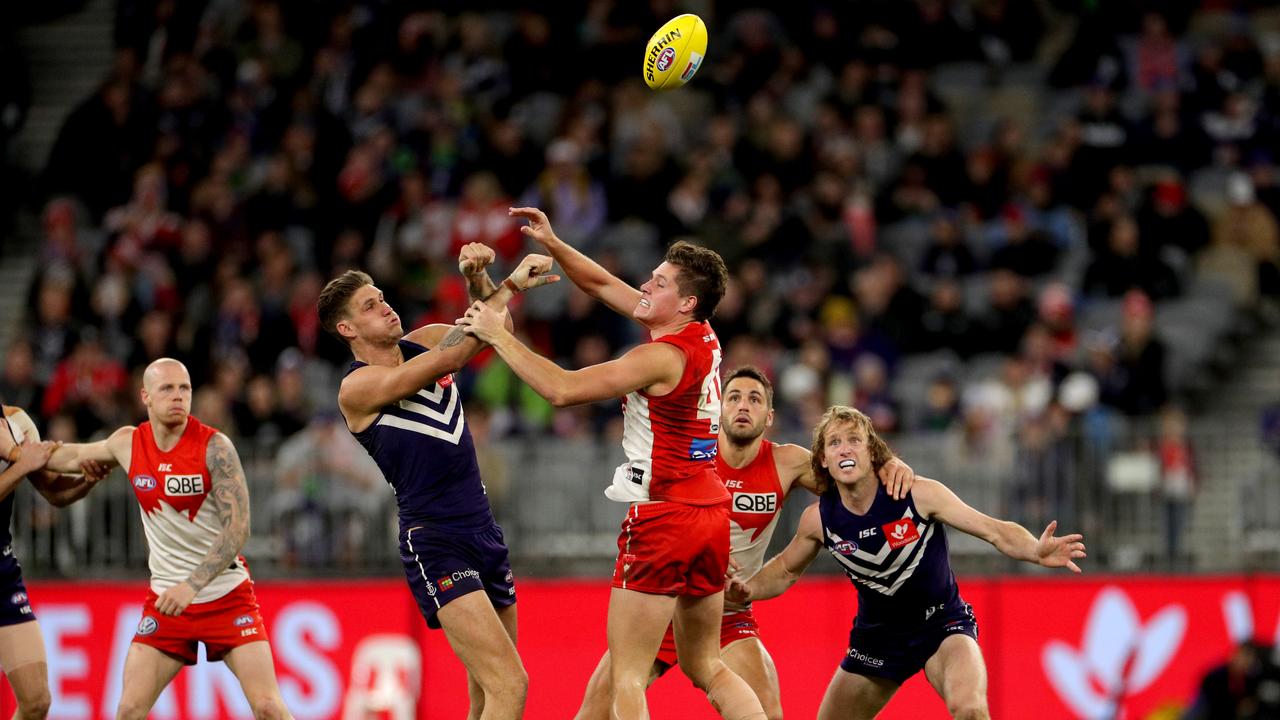 Hayden McLean does battle with Rory Lobb during his AFL debut in 2019. Picture: AAP Image/Richard Wainwright