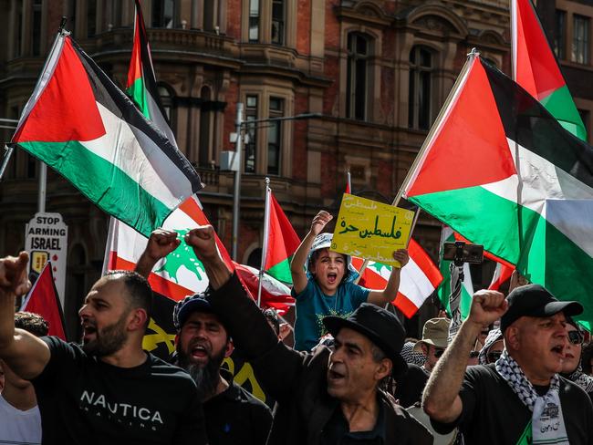 SYDNEY, AUSTRALIA - OCTOBER 06: Protesters march through the CBD on October 06, 2024 in Sydney, Australia. Organizers of pro-Palestine protests in Sydney are set to proceed with a rally on Sunday, October 6, despite legal attempts by police to prohibit the gatherings due to safety concerns related to anticipated crowd sizes and potential disruptions. The following day, a vigil is scheduled to honor victims of violence in Gaza, coinciding with the one-year anniversary of the Hamas attacks, which has drawn criticism from government officials who deem the timing "extremely provocative". Protesters also planned to gather for similar events in Melbourne. (Photo by Roni Bintang/Getty Images)