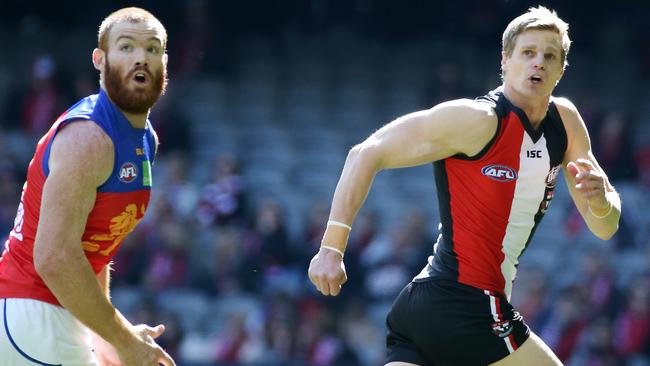 Daniel Merrett tries to keep up with Nick Riewoldt. Picture: George Salpigtidis