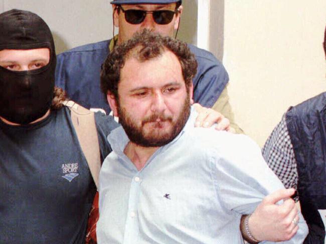 Giovanni Brusca, 36, one of Italy's most wanted fugitives, who is considered a top figure in the Mafia hierarchy, is escorted by masked policemen outside Police H.Q. in Palermo, Sicily, May 21, 1996. He is accused of setting off the roadside explosion that killed top Mafia prosecutor Giovanni Falcone in 1992.   AP Photo/Alessandro/Fucarini crime o/seas murder italy headshot