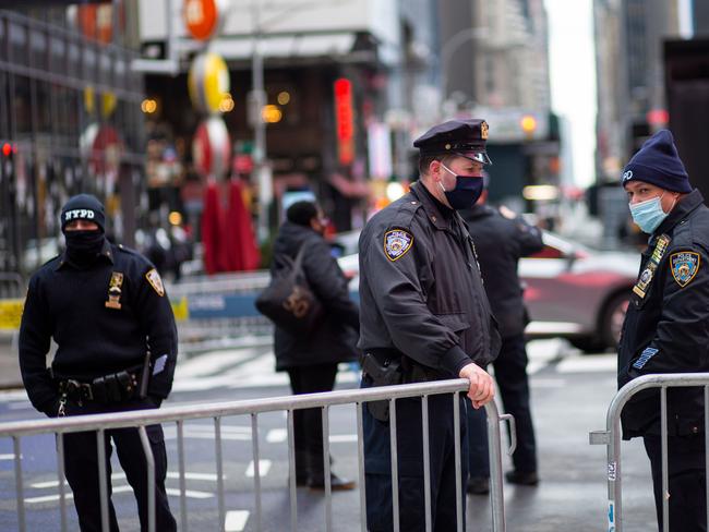 Police officers close the street with fences before the New Year's Eve celebration in Times Square, New York.