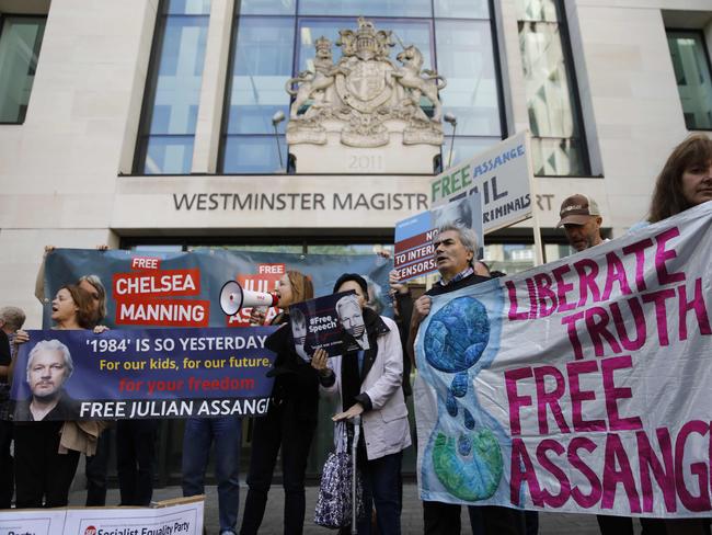 Julian Assange supporters hold placards and banners in protest outside Westminster Magistrates Court in London. Picture: AFP