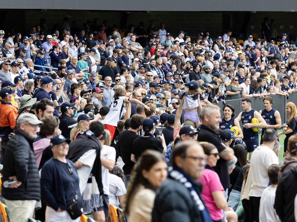 Happy Carlton fans at yesterday’s training session at the Gabba in Brisbane, ahead of today’s AFL Preliminary Final against the Brisbane Lions, show just how much the team’s fortunes have changed since the start of the season. Picture: Richard Walker