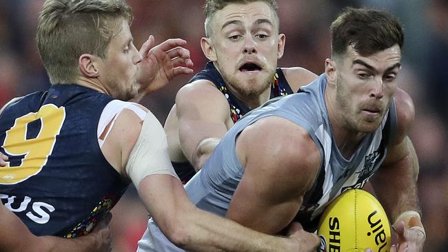 Port Adelaide’s Scott Lycett is tackled by Crows’ Rory Sloane (left) and Hugh Greenwood (now at Gold Coast) in Showdown 47 last season. Picture: Sarah Reed