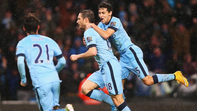 MANCHESTER, ENGLAND - JANUARY 01: Frank Lampard of Manchester City celebrates his team's third goal with Jesus Navas during the Barclays Premier League match between Manchester City and Sunderland at Etihad Stadium on January 1, 2015 in Manchester, England. (Photo by Alex Livesey/Getty Images)