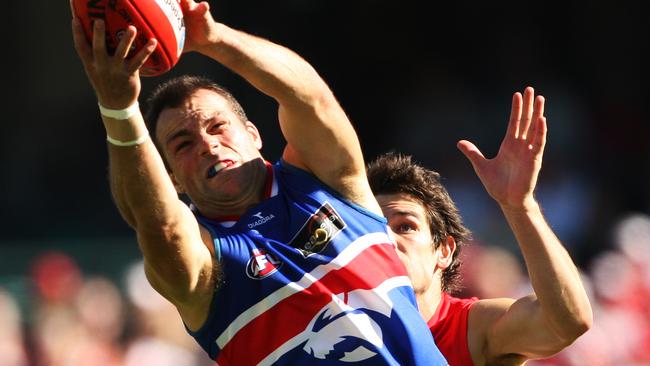 Brad Johnson marks ahead of Martin Mattner during the Sydney Swans v Western Bulldogs AFL match at the SCG in Sydney.