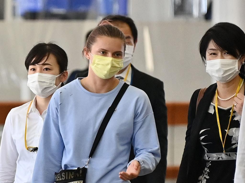 Belarus athlete Krystsina Tsimanouskaya (C) walks through Terminal 1 before boarding her Vienna-bound flight at Narita International Airport in Narita, outside Tokyo. Picture: AFP