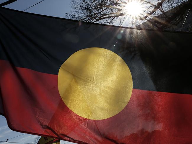 MELBOURNE, AUSTRALIA - JULY 05:  The Indigenous Flag is seen flying during the NAIDOC March. Debate has begun around who owns the Indigenous Flag and who can use it under copyright law. The march marks the start of NAIDOC Week, which runs in the first full week of July each year. NAIDOC Week celebrations are held across Australia to celebrate the history, culture and achievements of Aboriginal and Torres Strait Islander peoples. NAIDOC is celebrated not only in Indigenous communities, but by Australians from all walks of life. (Photo by Darrian Traynor/Getty Images)