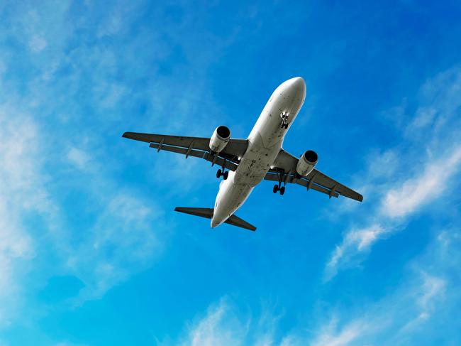 jet airplane landing in bright wispy sky, square frame (XL)