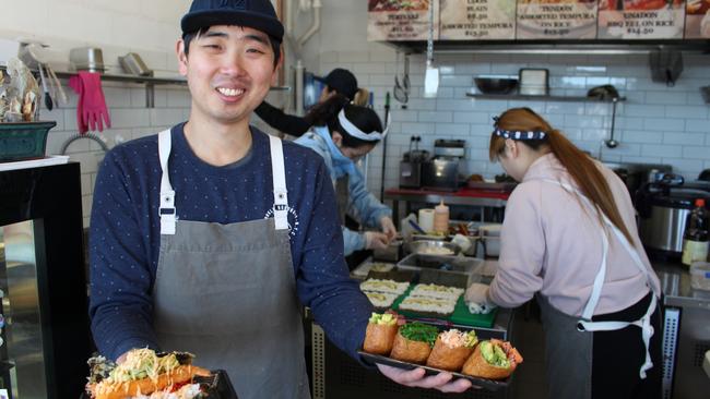 Umami owner Dean Han with two of their signature dishes.