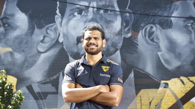 Hawthorn player Cyril Rioli in front of a huge mural in Hawthorn. Picture: David Caird