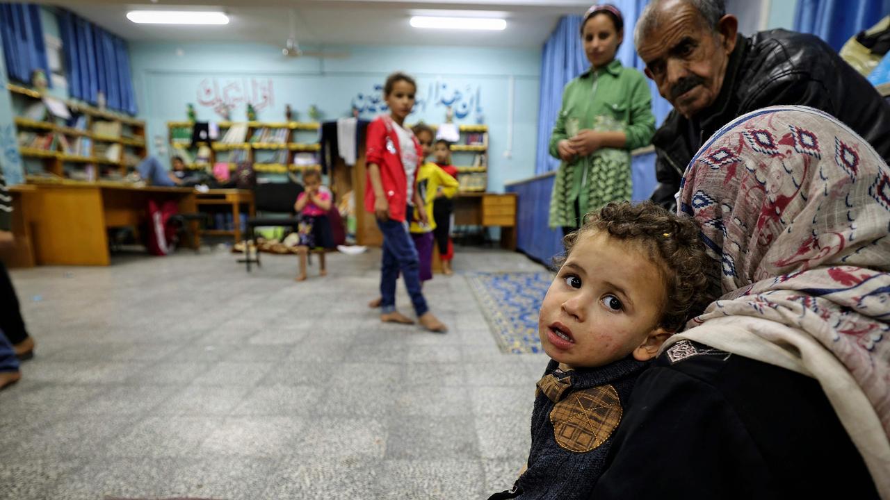 Palestinian families take shelter in a UN school in Gaza City on May 13, 2021, after fleeing from their homes in the town of Beit Lahia. Picture: Mahmud Hams/AFP