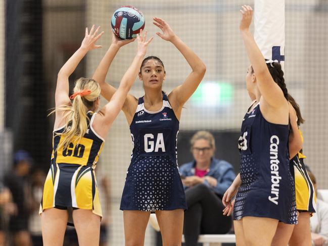 Canterbury College (navy blue) vs. Xavier Catholic College (black and gold). Canterbury CollegeÃ¢â&#130;¬â&#132;¢s Kaylee Tamale looks to make a pass during their game against Xavier Catholic College.