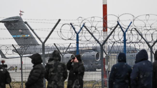 US Army soldiers and military vehicles exit a US Air Force Boeing C-17A Globemaster III transport aircraft at Poland’s Jasionka Rzeszow Airport on February 6 as part of a military reinforcement to deter war between Russia and the Ukraine. Picture: Getty