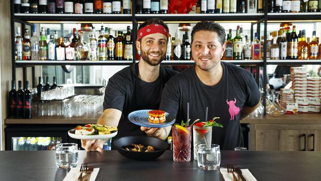 New tapas and wine bar Miguel's has opened on the southern end of Williams Esplanade at Palm Cove. Miguel's head chef Andrea Gennusa and general manager Nick Penna serve up the Mantecato de Barra, whipped barramundi with sun dried tomatoes, and the Chips di Pimenton, paprika chips with goats cheese. Picture: Brendan Radke