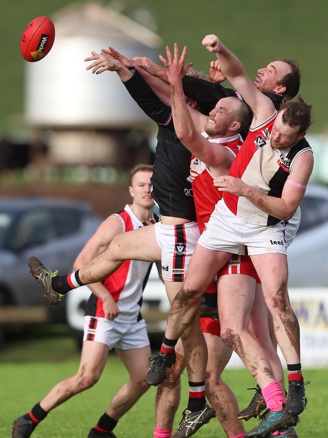 Alvie’s Lincoln Dare is sandwiched between three Birregurra opponents Mitchell Jones, James Rowan and Joel Hayward.