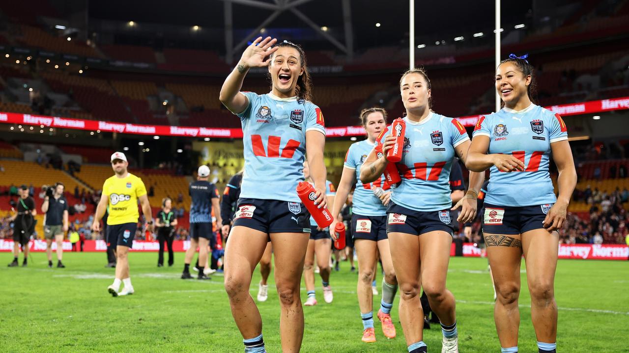 BRISBANE, AUSTRALIA - MAY 16: Corban Baxter of the Blues, Isabelle Kelly of the Blues and Tiana Penitani of the Blues thank fans after winning game one of the 2024 Women's State of Origin series between Queensland and New South Wales at Suncorp Stadium on May 16, 2024 in Brisbane, Australia. (Photo by Hannah Peters/Getty Images)