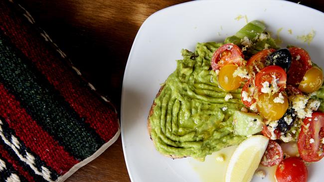 Avocado smash with heirloom tomatoes, cokelek cheese, olives, nigella seeds and a lemon wedge.