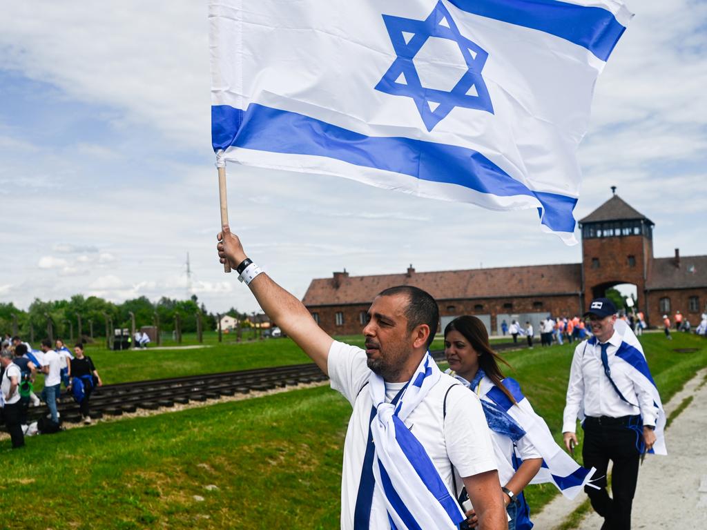 Participants enter Auschwitz-Birkenau with Israel’s national flag during the 36th March of the Living in Oswiecim, Poland. The event takes place on Yom HaShoah, as thousands march three kilometres between Auschwitz I and Birkenau in remembrance of Holocaust victims. Picture: Omar Marques/Getty Images