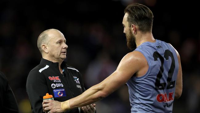 Ken Hinkley and Charlie Dixon speak during the Essendon game. Picture: AAP/Mark Dadswell