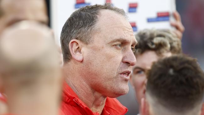 MELBOURNE, AUSTRALIA - JULY 02: John Longmire, senior coach of the Sydney Swans  speaks to his players during the round 16 AFL match between the Essendon Bombers and the Sydney Swans at Melbourne Cricket Ground on July 02, 2022 in Melbourne, Australia. (Photo by Darrian Traynor/AFL Photos/via Getty Images)