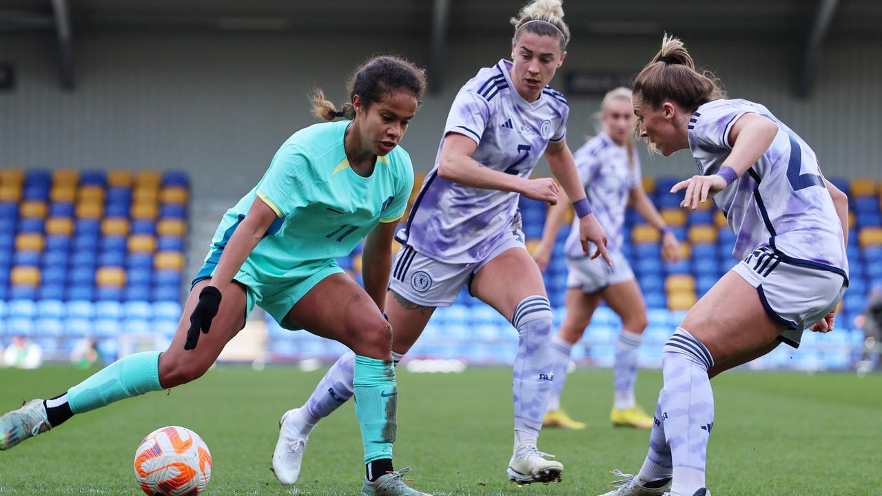 WIMBLEDON, ENGLAND - APRIL 07: Mary Fowler of Australia controls the ball whilst under pressure from Nicola Docherty of Scotland during the Women's International Friendly match between Australia and Scotland at The Cherry Red Records Stadium on April 07, 2023 in Wimbledon, England. (Photo by Tom Dulat/Getty Images)