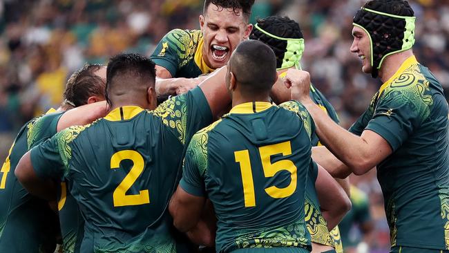 OITA, JAPAN - OCTOBER 05: James Slipper (obscured) of Australia is congratulated by his team mates after scoring his side's sixth try during the Rugby World Cup 2019 Group D game between Australia and Uruguay at Oita Stadium on October 05, 2019 in Oita, Japan. (Photo by Dan Mullan/Getty Images)