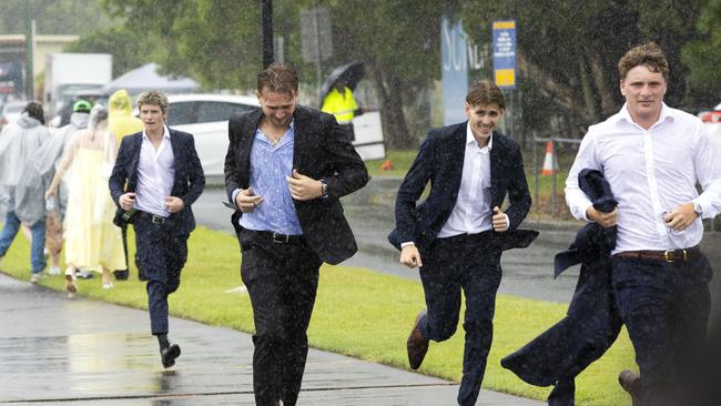 People leaving a wet Magic Millions Raceday at Gold Coast Turf Club, Saturday, January 11, 2025 - Picture: Richard Walker