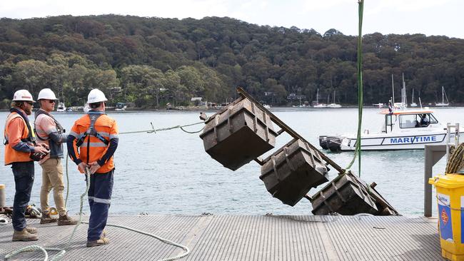 Roads and Maritime Services recovering building materials that have been dumped in Pittwater off Scotland Island. Photo Manly Daily