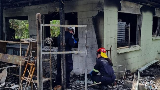 A joint investigation into a house fire at Koah was underway on February 28, between Quoteland Fire and Rescue Service and Queensland Police at Barron St, Koah, on February 28, 2023. QFES Fire Investigator Aeron Holzhauser (in red and yellow helmet) with a Mareeba Scenes of Crime officer (white helmet) conduct their investigation. Picture: Supplied