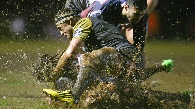 Jordy Reid of the Rebels is tackled by Hugh Renton of the Hurricanes.