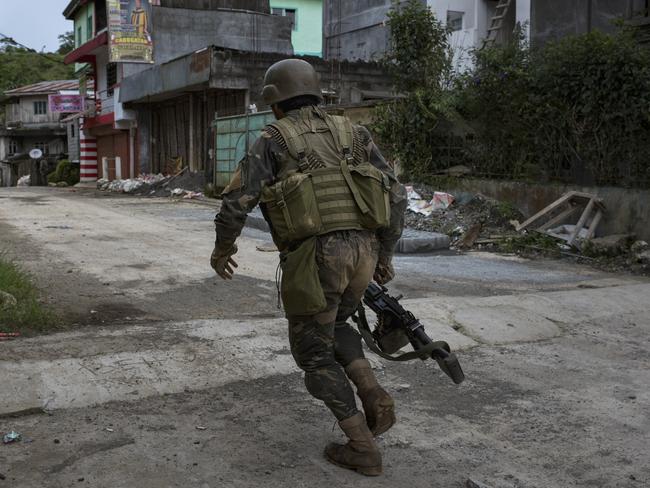 Soldiers run for cover in Marawi city during gunbattles between ISIS-linked militants and Filipino troops in May. Picture: Jes Aznar/Getty Images