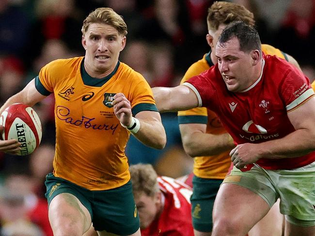 CARDIFF, WALES - NOVEMBER 17: Tate McDermott of Australia runs with the ball after evading Tommy Reffell and Ryan Elias of Wales during the Autumn Nations Series 2024 match between Wales and Australia at the Principality Stadium on November 17, 2024 in Cardiff, Wales. (Photo by David Rogers/Getty Images)