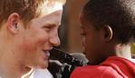 LESOTHO - APRIL 24: (EMBARGOED: NOT FOR PUBLICATION BEFORE 0001 FRIDAY APRIL 28, 2006.) Prince Harry holds his old friend, Mutsu Potsane, in the grounds of the Mants'ase children's home, while on a return visit to Lesotho on April 24, 2006 in southern Africa. The Prince was in the country to launch his new charity called 'Sentebale', which means 'Forget me not' in memory of his mother Princess Diana. (Photo by Pool/Anwar Hussein Collection/Getty Images)