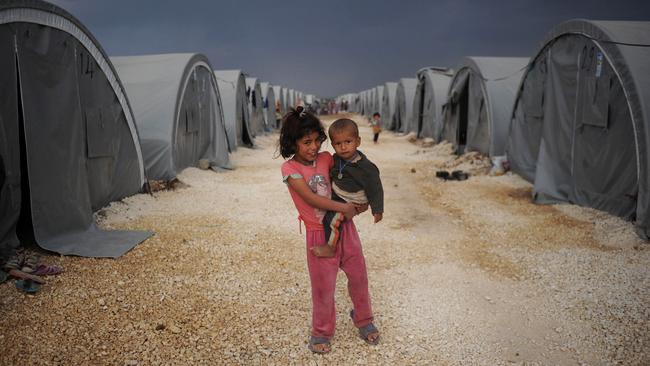 Two Kurdish refugee children from the Syrian town of Kobani pictured in a makeshift camp in Turkey. Picture: Kutluhan Cucel/Getty Images