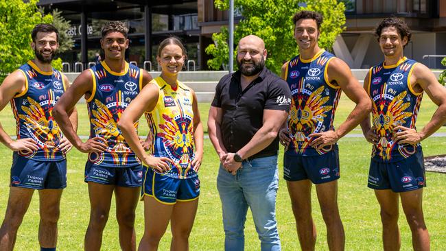 AFL and AFLW Crows players in the 2022 Adelaide Crows Indigenous guernsey at the Adelaide Oval. From left, Wayne Milera Jnr, Tariek Newchurch, Danielle Ponter, designer Pat Caruso, Ben Davis, Shane McAdam Picture: Supplied