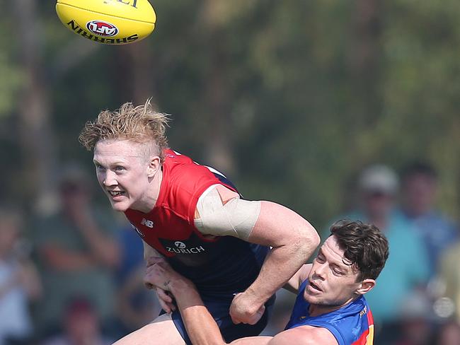 Clayton Oliver can’t escape Brisbane's Lachie Neale. Picture: Michael Klein