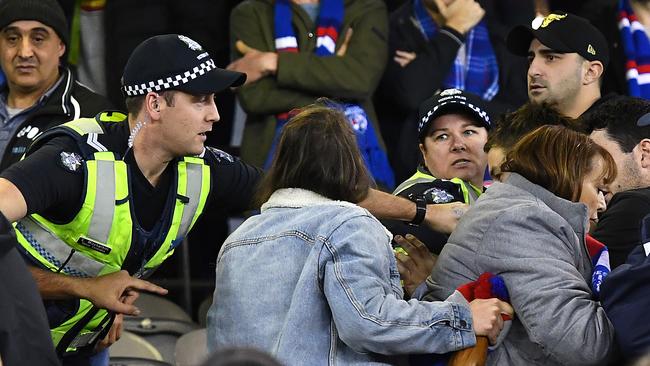 Police intervened in a fight at Marvel Stadium while some fans looked on and others scrambled to get away. Picture: Quinn Rooney/Getty Images