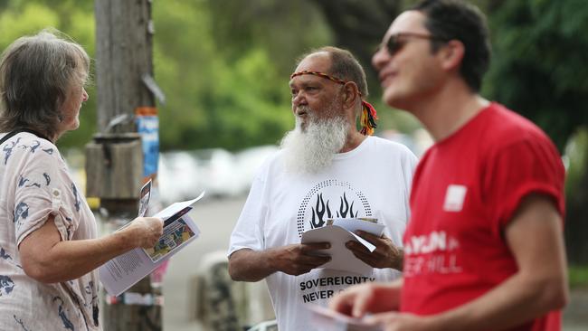 Volunteer Judulu hands out material at the Marrickville market. Picture: John Feder/The Australian