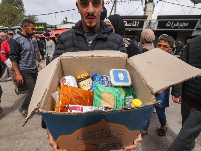 A man presents the contents of a cardboard box of food aid provided by non-profit non-governmental organisation World Central Kitchen in Rafah. Picture: AFP