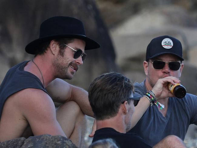 Matt Damon joined the Hemsworth family for a beer on the beach. Picture: KHAPGG / MEGA