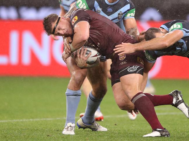 Titans prop Jarrod Wallace is wrapped up by the NSW defence in last night’s 38-6 win over Queensland in Perth. Picture: Mark Kolbe/Getty Images