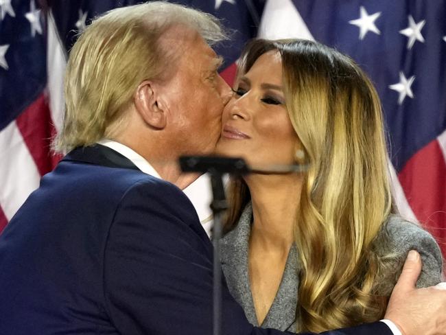 Republican presidential nominee former President Donald Trump, left, kisses Melania Trump at an election night watch party, Wednesday, Nov. 6, 2024, in West Palm Beach, Fla. (AP Photo/Alex Brandon)