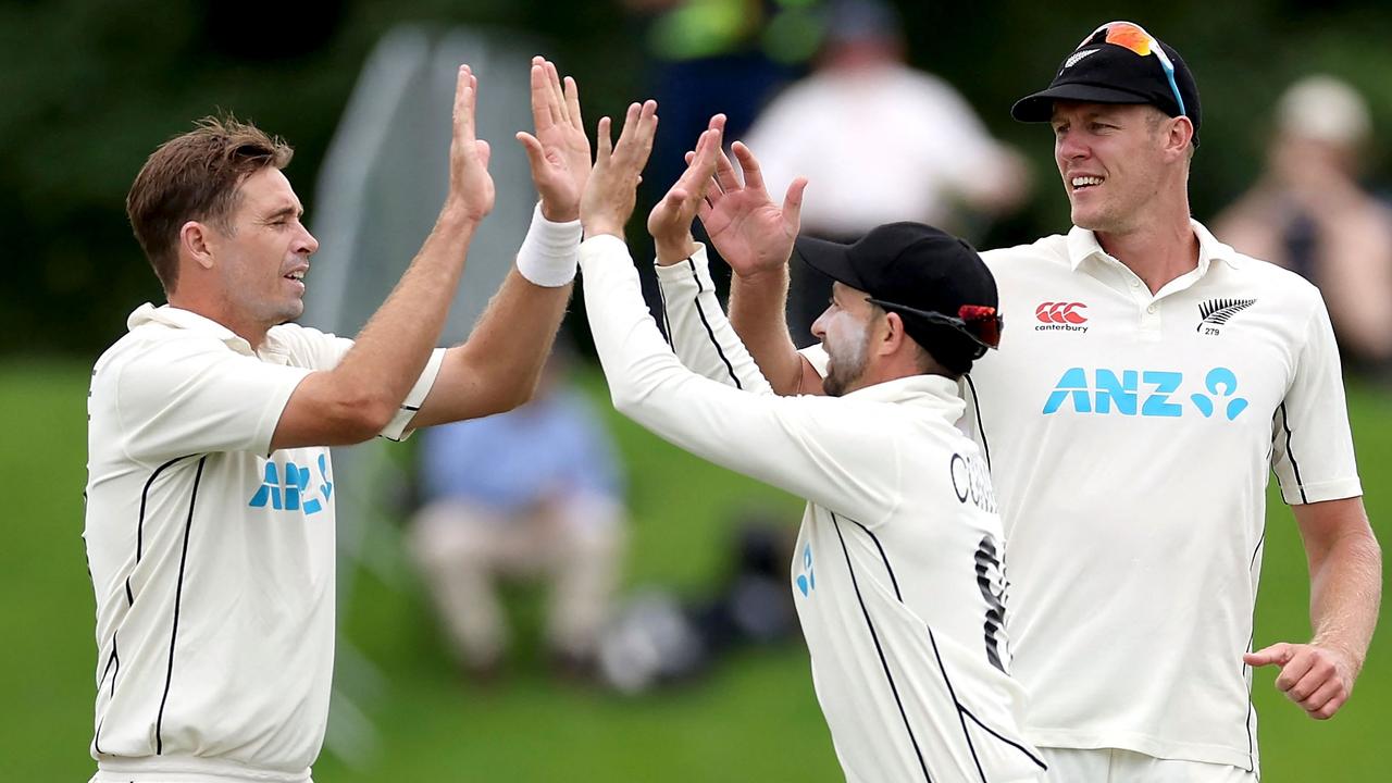 New Zealand's Tim Southee (L) celebrates the wicket of South Africa's Kyle Verreynne with teammates Devon Conway (C) and Kyle Jamieson during day three of the first cricket Test match between New Zealand and South Africa at Hagley Oval in Christchurch on February 19, 2022. (Photo by Marty MELVILLE / AFP)