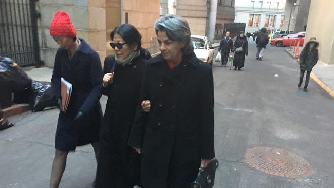 Sheri Yan (centre), the Chinese wife of former Australian spy Roger Uren, arrives at court in Manhattan where she pleaded guilty to bribery.