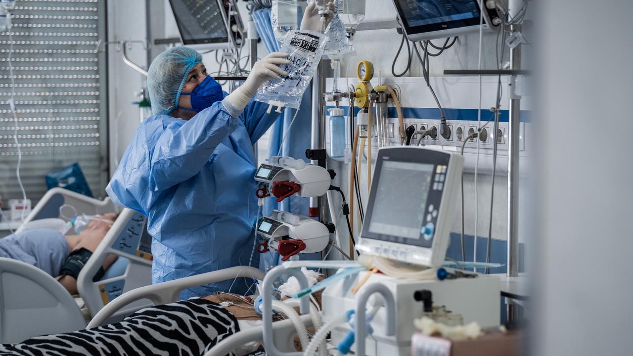 A nurse wearing a protective mask while taking care of patient in the ICU of St Anna Hospital in Sofia, Bulgaria.