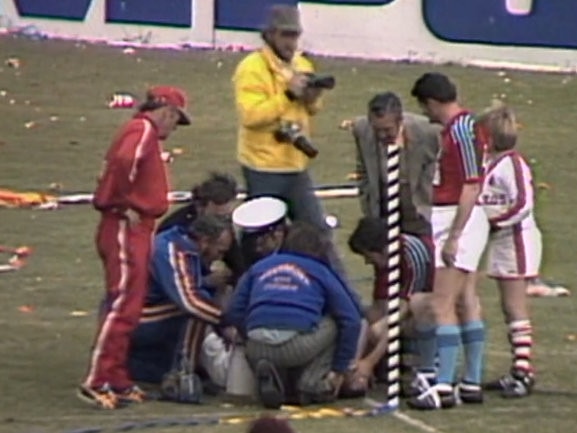 Brian Barry (obscured) being treated after being hit in the groin by an apple at the 1977 rugby league grand final replay at the SCG. Picture: Supplied