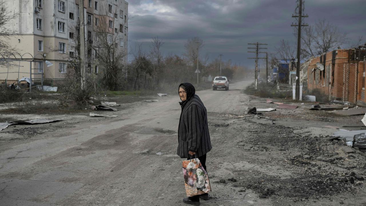 A woman walks in the Kherson region village of Arkhanhelske (Photo by BULENT KILIC / AFP)